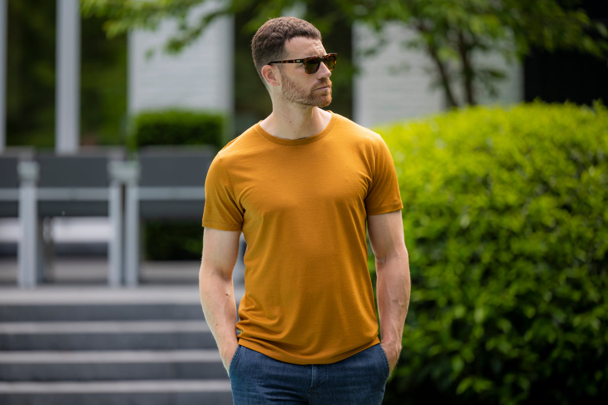 Man wears merino wool T-shirt in summer setting
