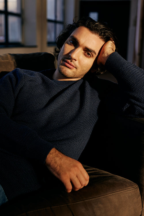 Man wearing merino wool sweater in navy blue color with crew neck from Wolk antwerp