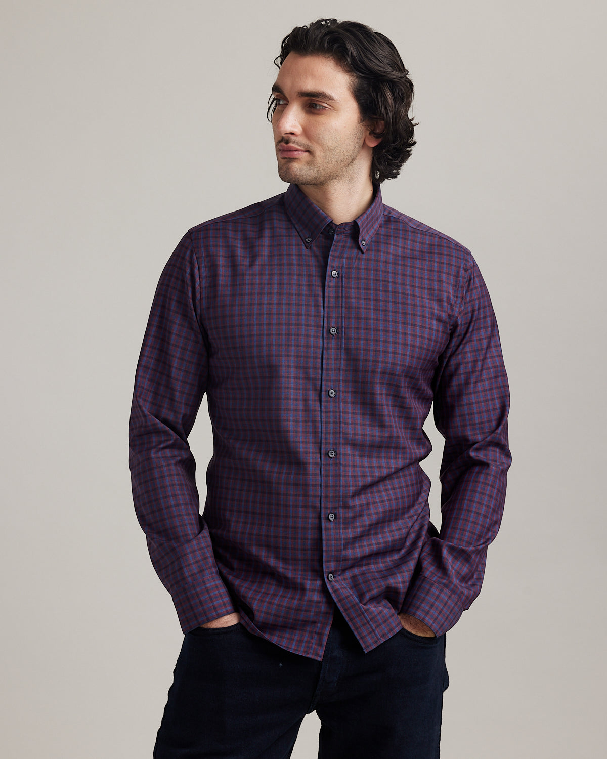 Man wears button down Alex merino wool shirt with checks in burgundy and navy colors in slim fit