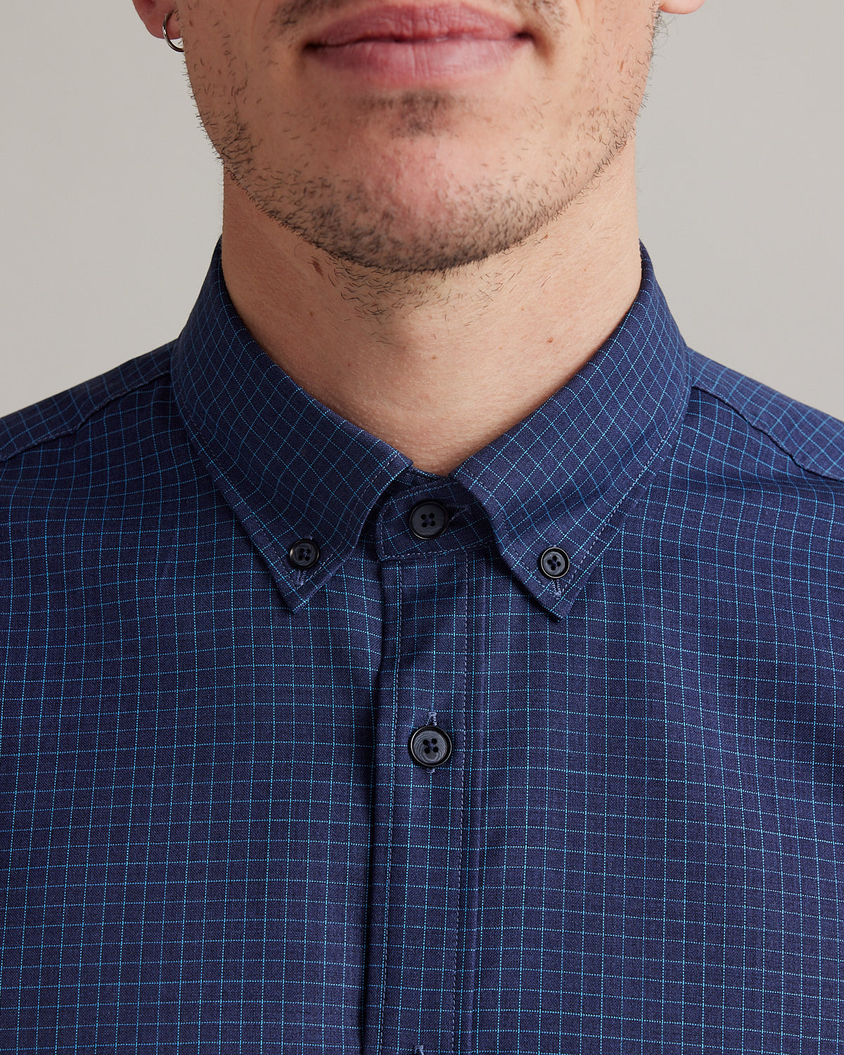 button down collar on navy blue merino shirt with light blue graph check and corozo buttons
