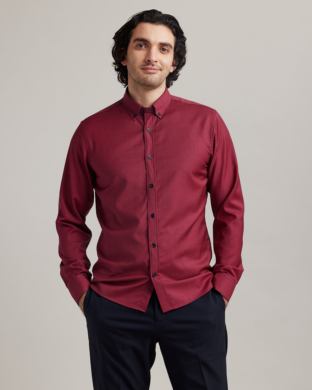 Wolk - man wearing an Alex merino shirt with button down collar in red navy mini gingham in slim fit
