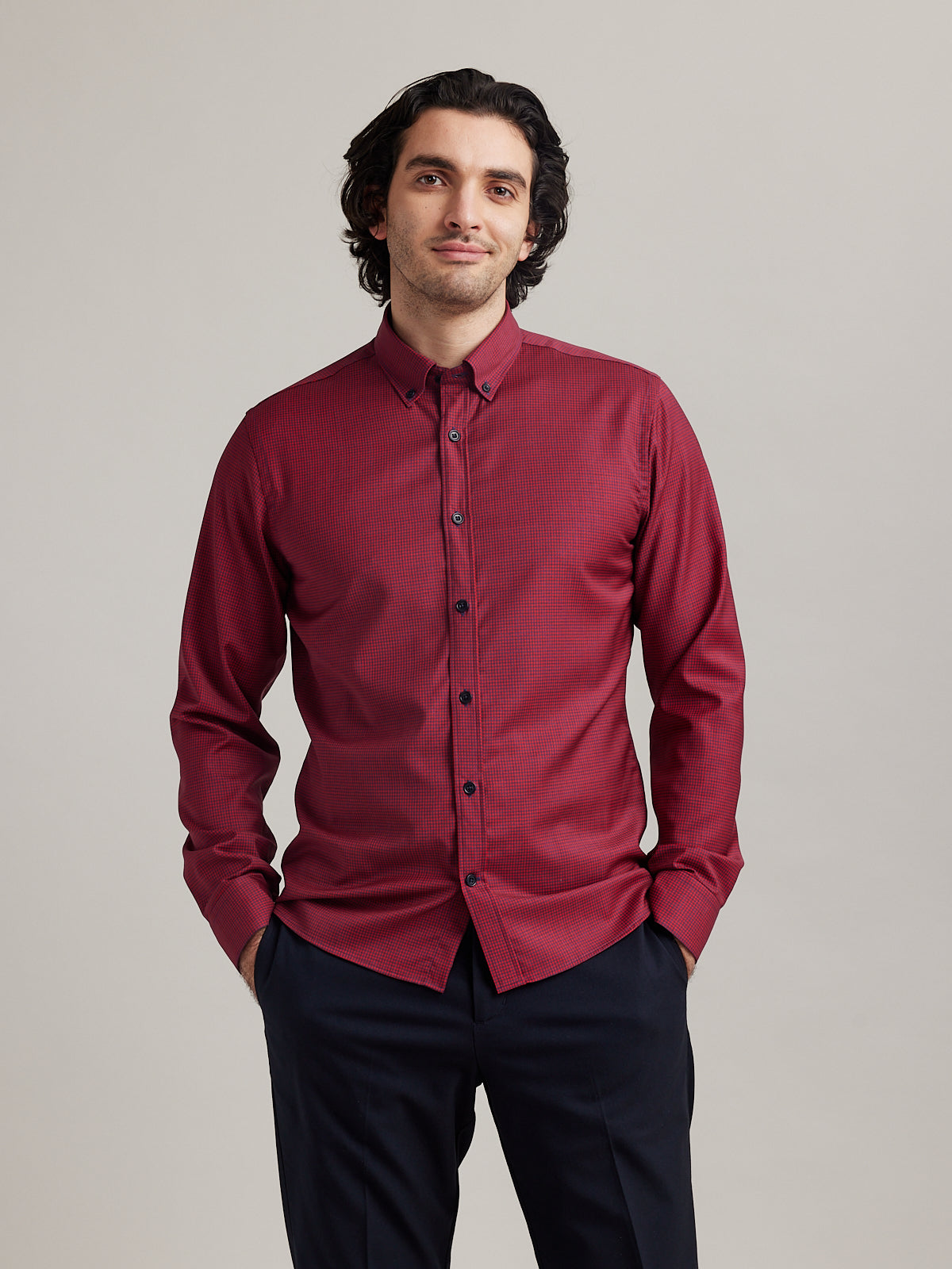 Wolk - man wearing an Alex merino shirt with button down collar in red navy mini gingham in slim fit
