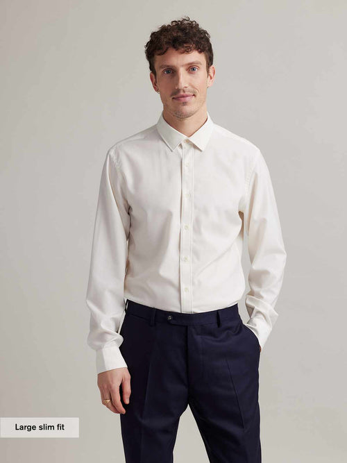 Man wearing a long sleeve merino dress shirt in white in slim fit