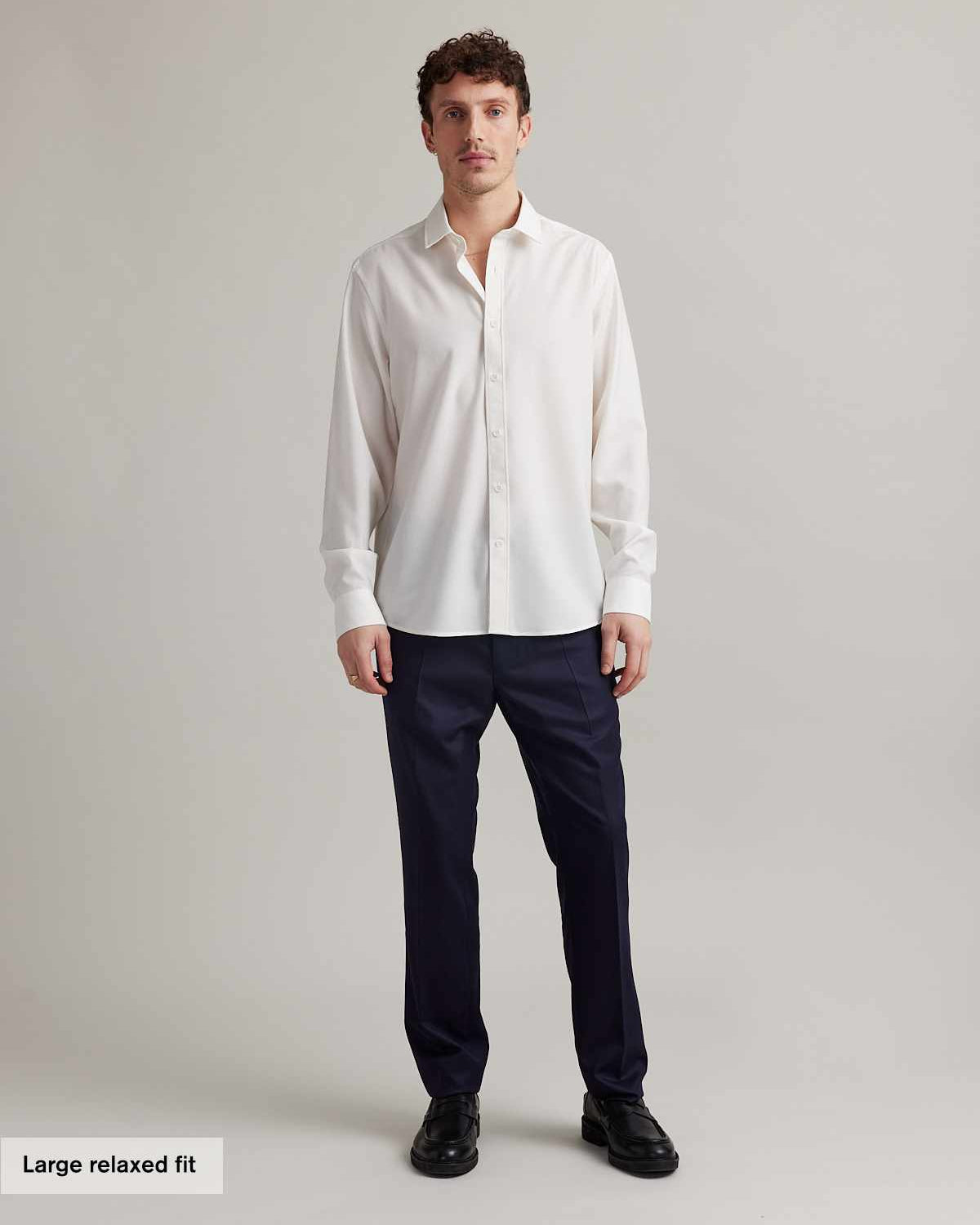 Man wearing a long sleeve merino dress shirt in white and relaxed fit