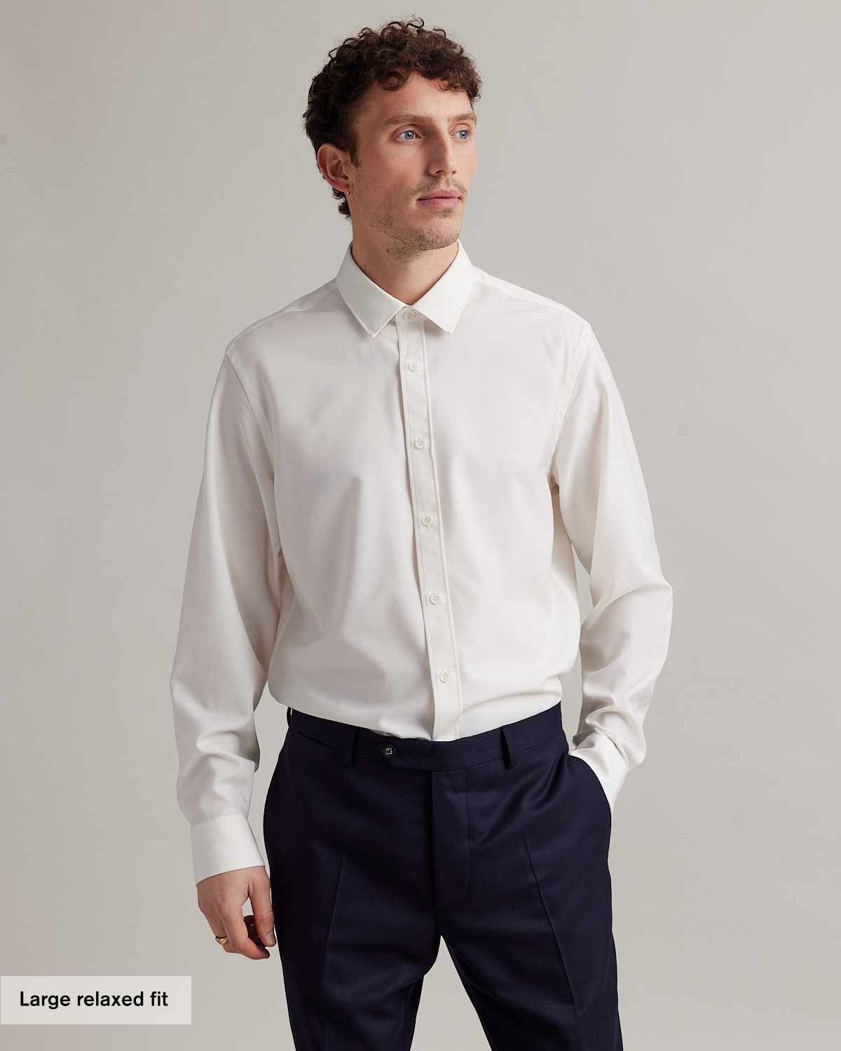 Man wearing a long sleeve merino dress shirt from Wolk in white with classic collar and white buttons in relaxed fit