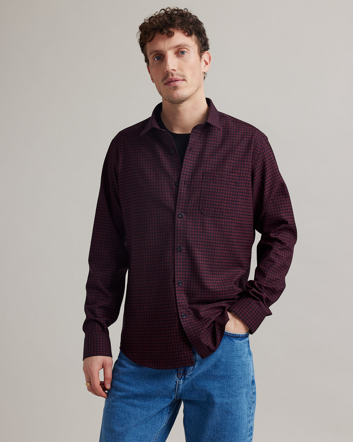 Man wearing navy red gingham flannel merino wool shirt with chest pocket