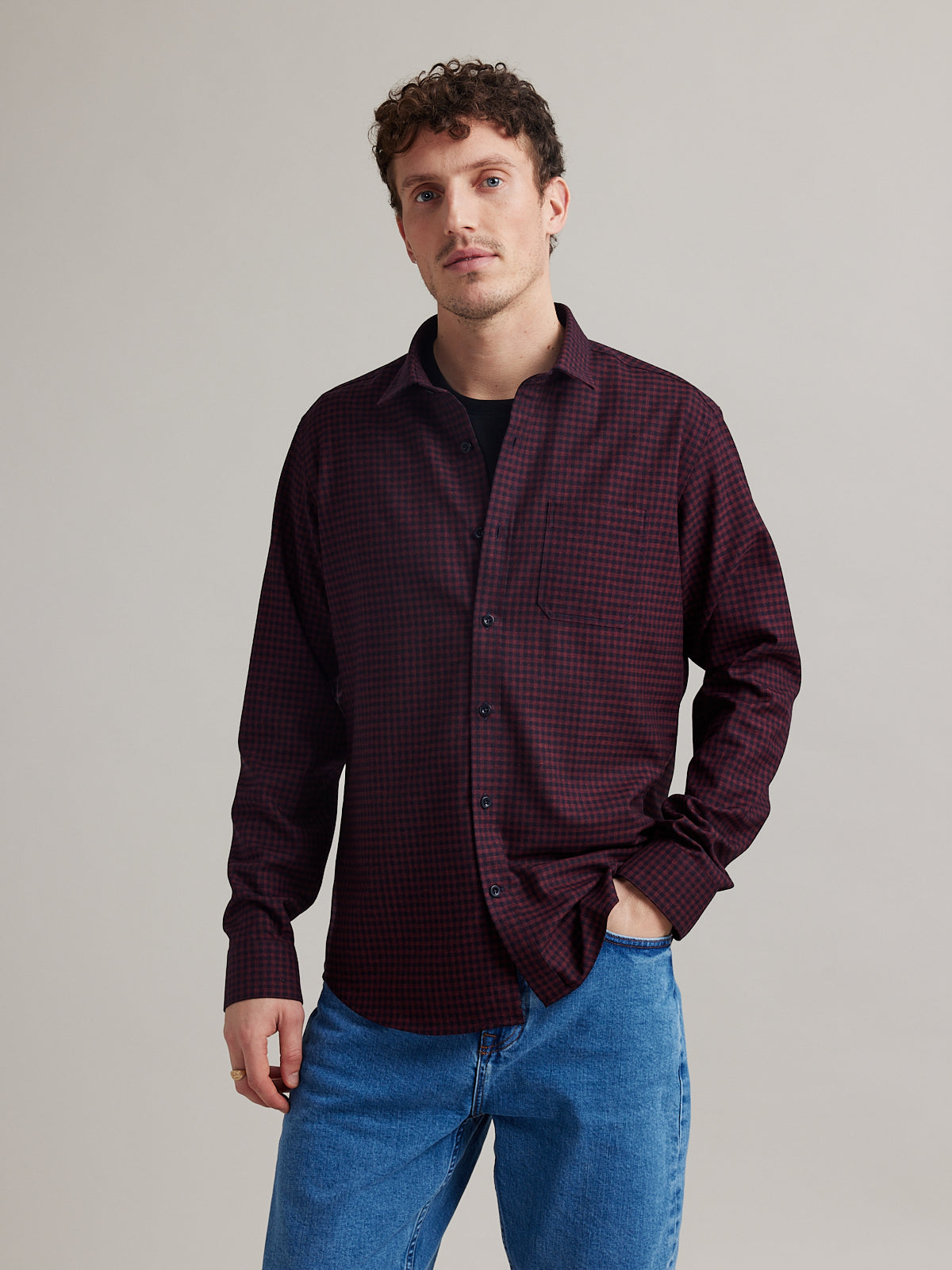 Man wearing navy red gingham flannel merino wool shirt with chest pocket