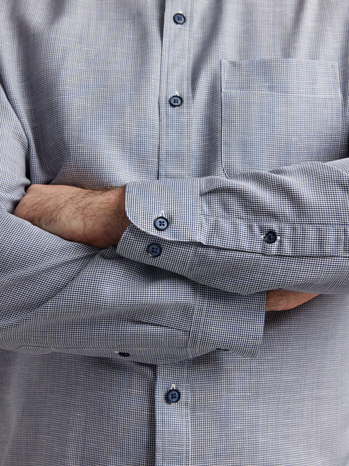 cuff detail of a merino wool and linen shirt from Wolk in dark navy houndstooth