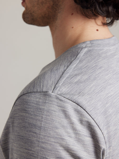 Shoulder detail of a men’s merino wool T-shirt in light grey melange from the Wolk Brand.