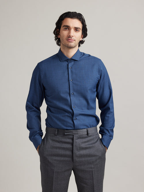 man wearing a navy coloured merino wool shirt with long sleeves from Wolk in slim fit