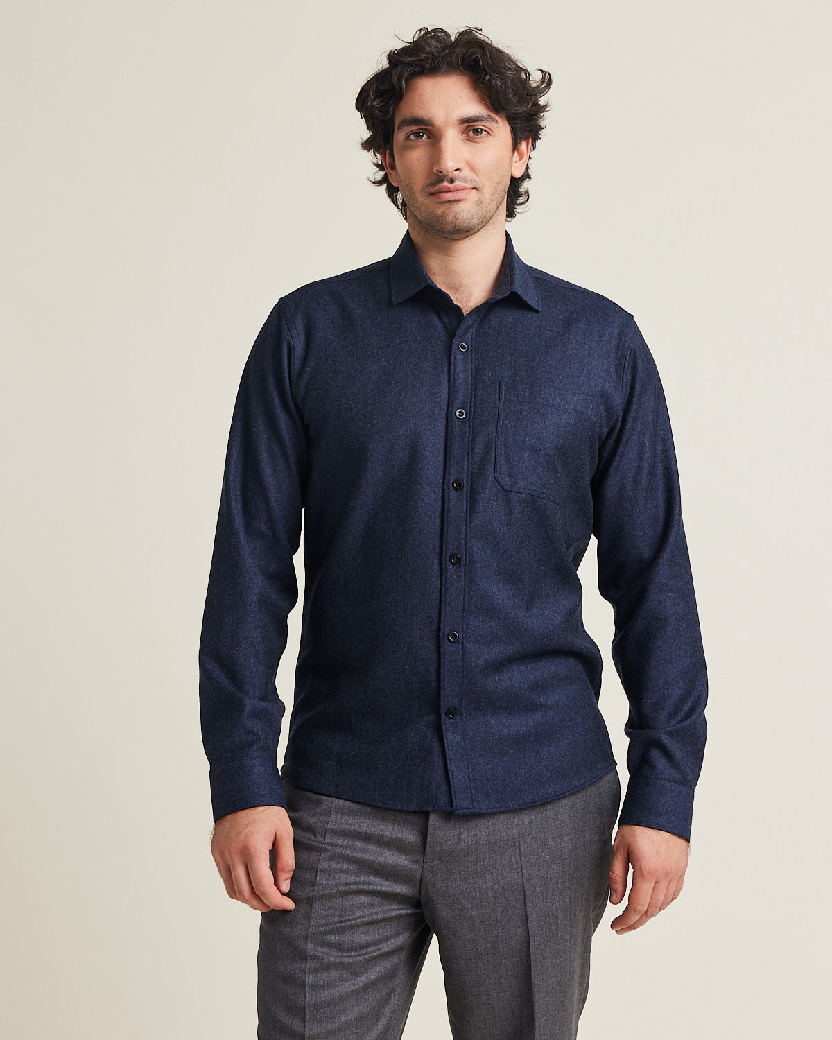 Man wears a merino wool flannel shirt 100% merino in navy colour with chest pocket in regular fit