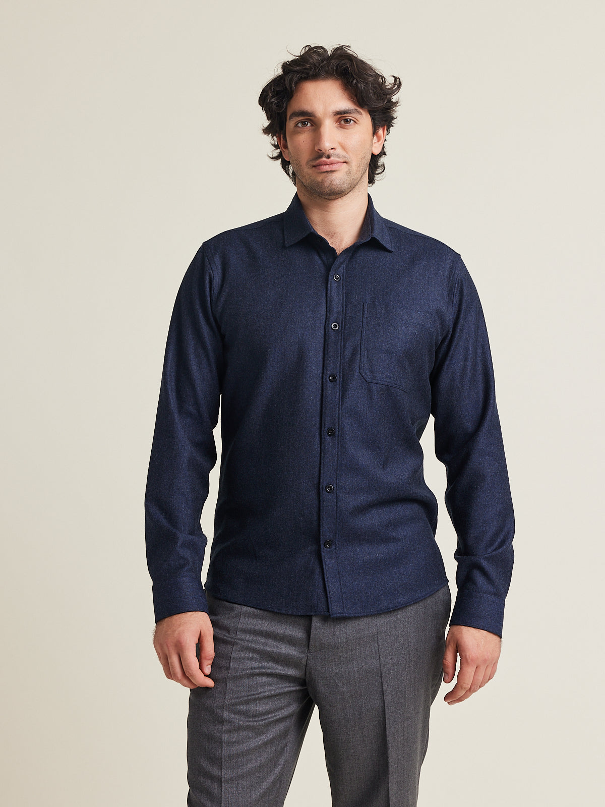Man wears a merino wool flannel shirt 100% merino in navy colour with chest pocket in regular fit