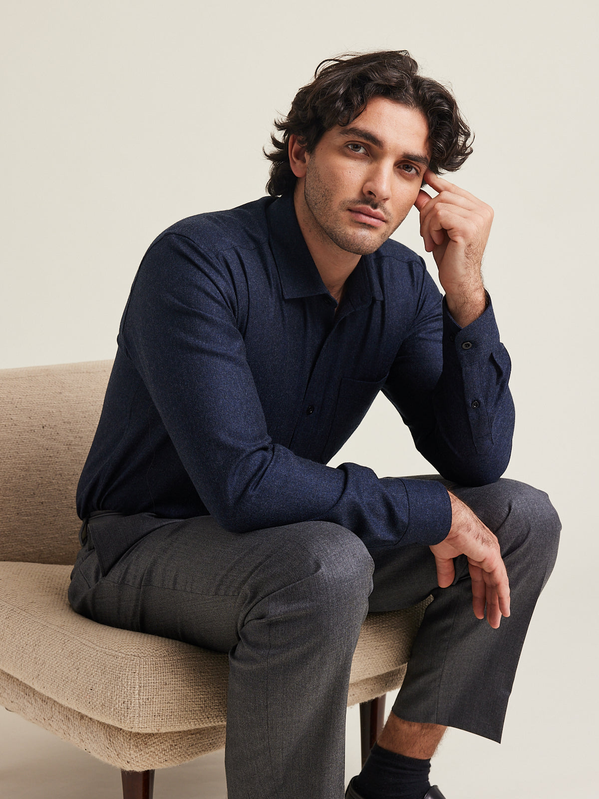 Man wears Wolk flannel merino shirt in navy melange color on grey trousers
