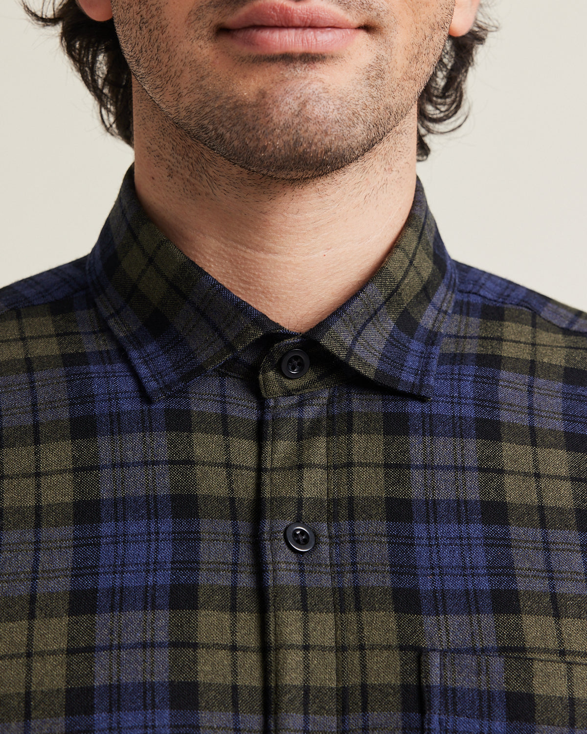 Close up of merino wool flannel shirt in blue green check pattern with blue corozo buttons from Wolk