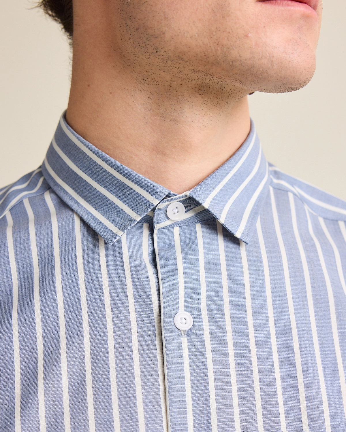 Collar close up of a stripes pattern merino wool shirt for men.