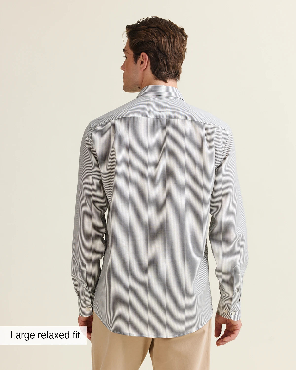 Back view of a man wearing anavy bengal striped merino shirt on a beige pants in relaxed fit from Wolk
