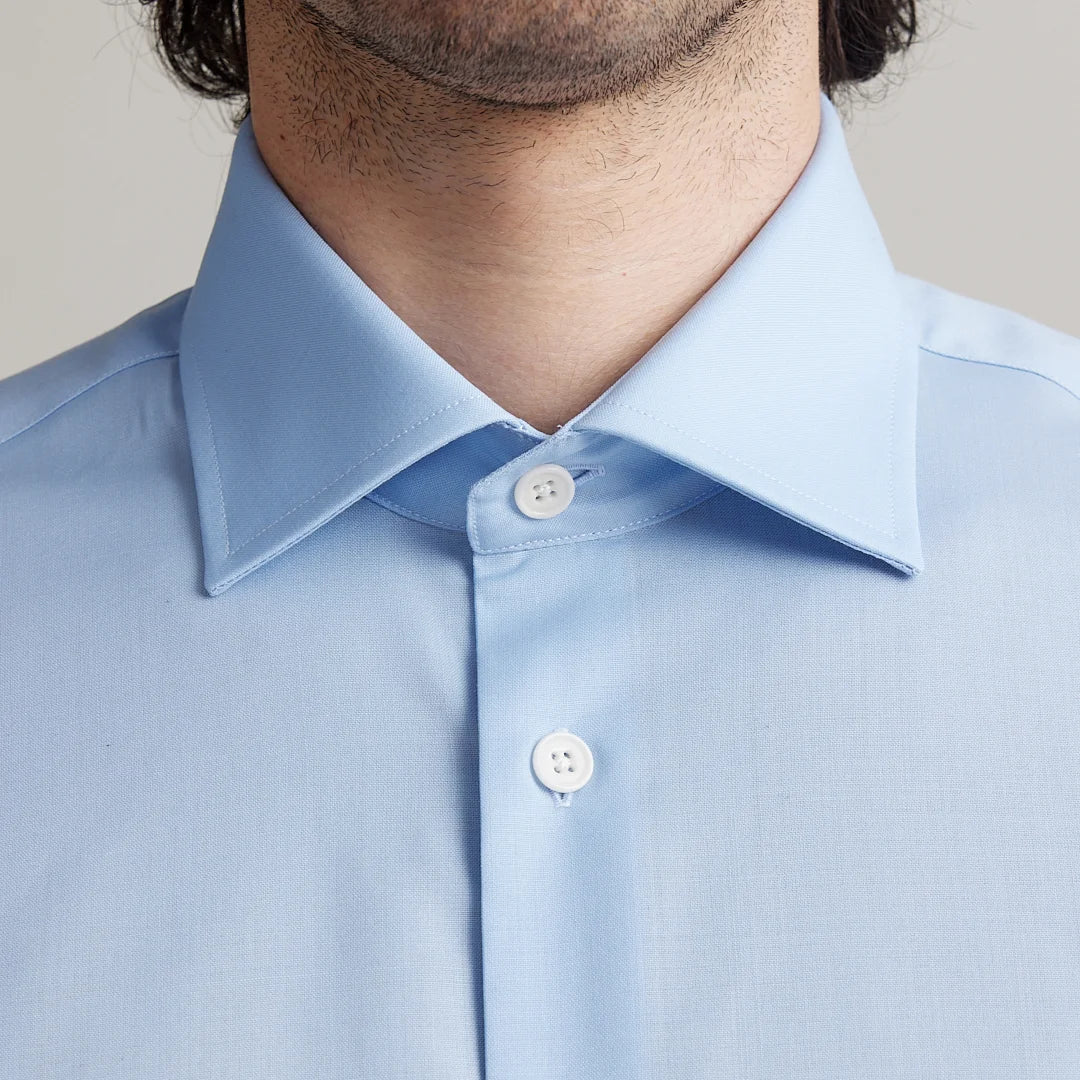 close up of light blue merino wool dressed shirt with English spread collar and white corozo buttons