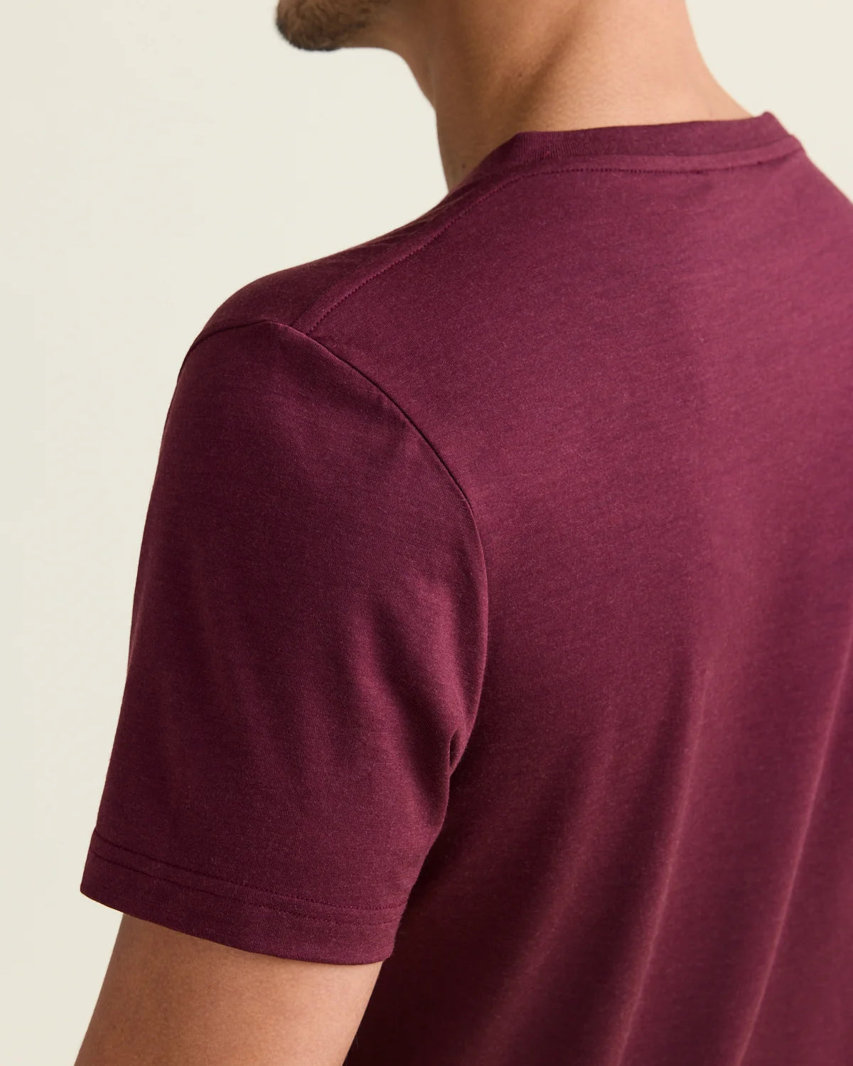 Shoulder detail of merino wool T-shirt in burgundy red color with short sleeves