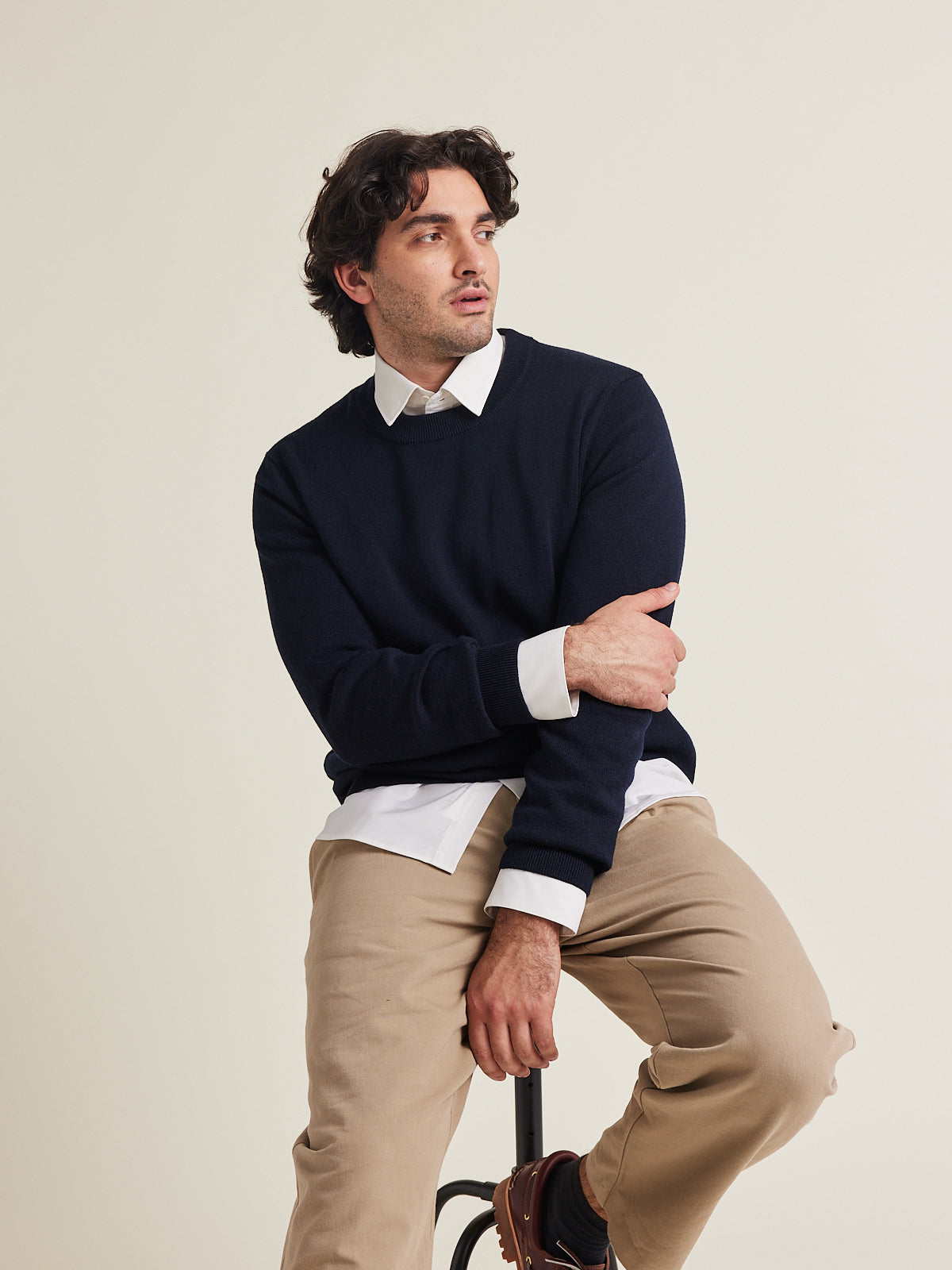 Man wears a dark navy merino wool sweater on a white merino wool shirt from Wolk 100% merino wool made in Portugal