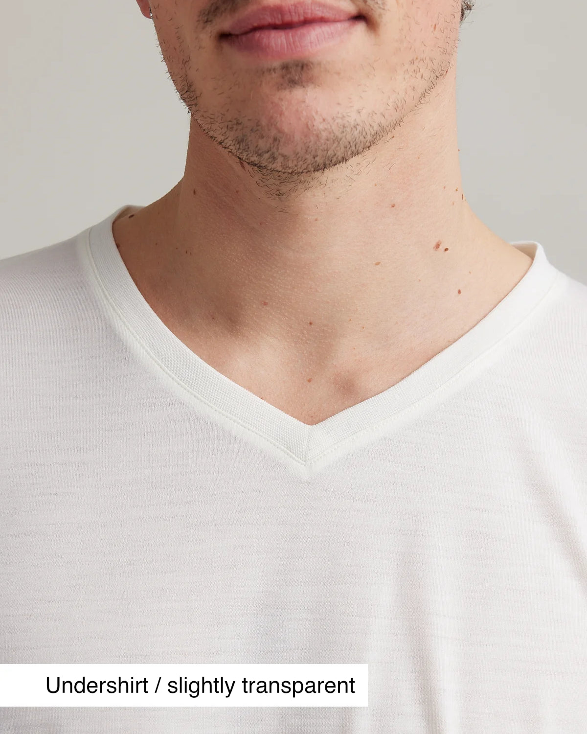 Close up of V neck collar on white merino T-shirt for men