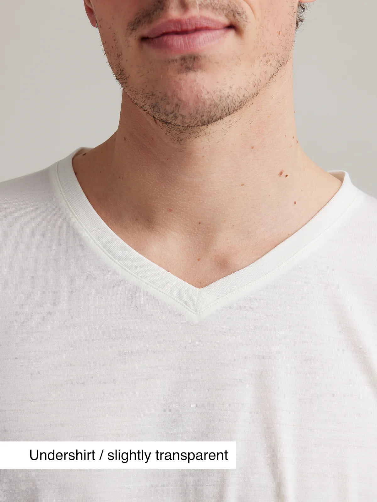 Close up of V neck collar on white merino T-shirt for men