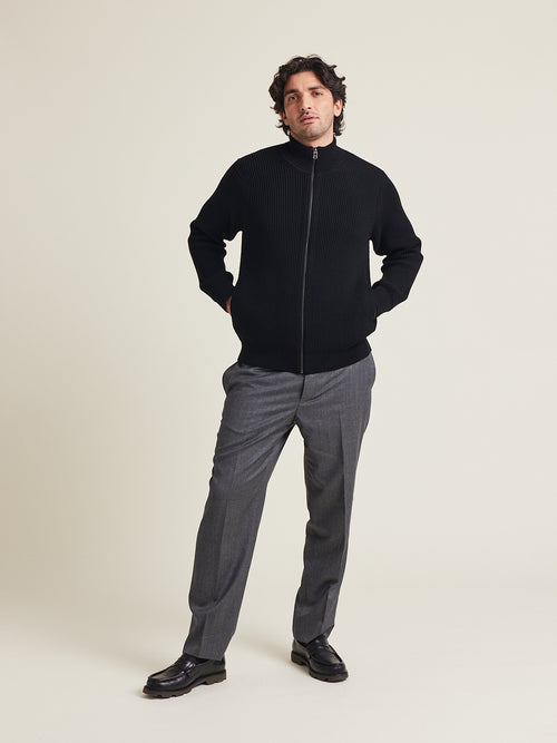 Man wears heavy weight merino wool vest in black with zip and side pockets