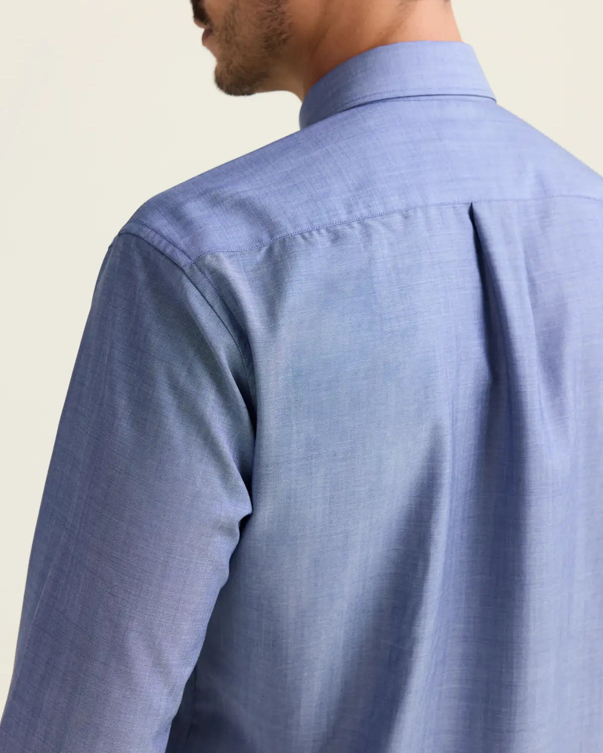 Light blue denim merino shirt shot from the back, highlighting the back pleat.