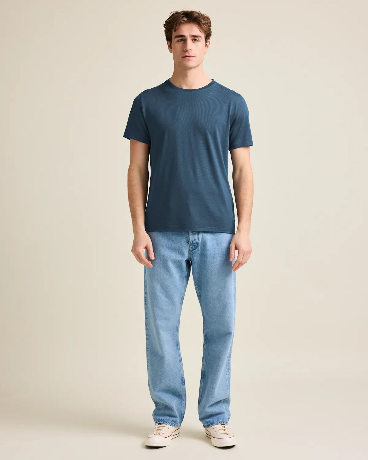Wolk's denim blue men's merino wool T-shirt in a studio setting, showcasing crew-neck design and short sleeves