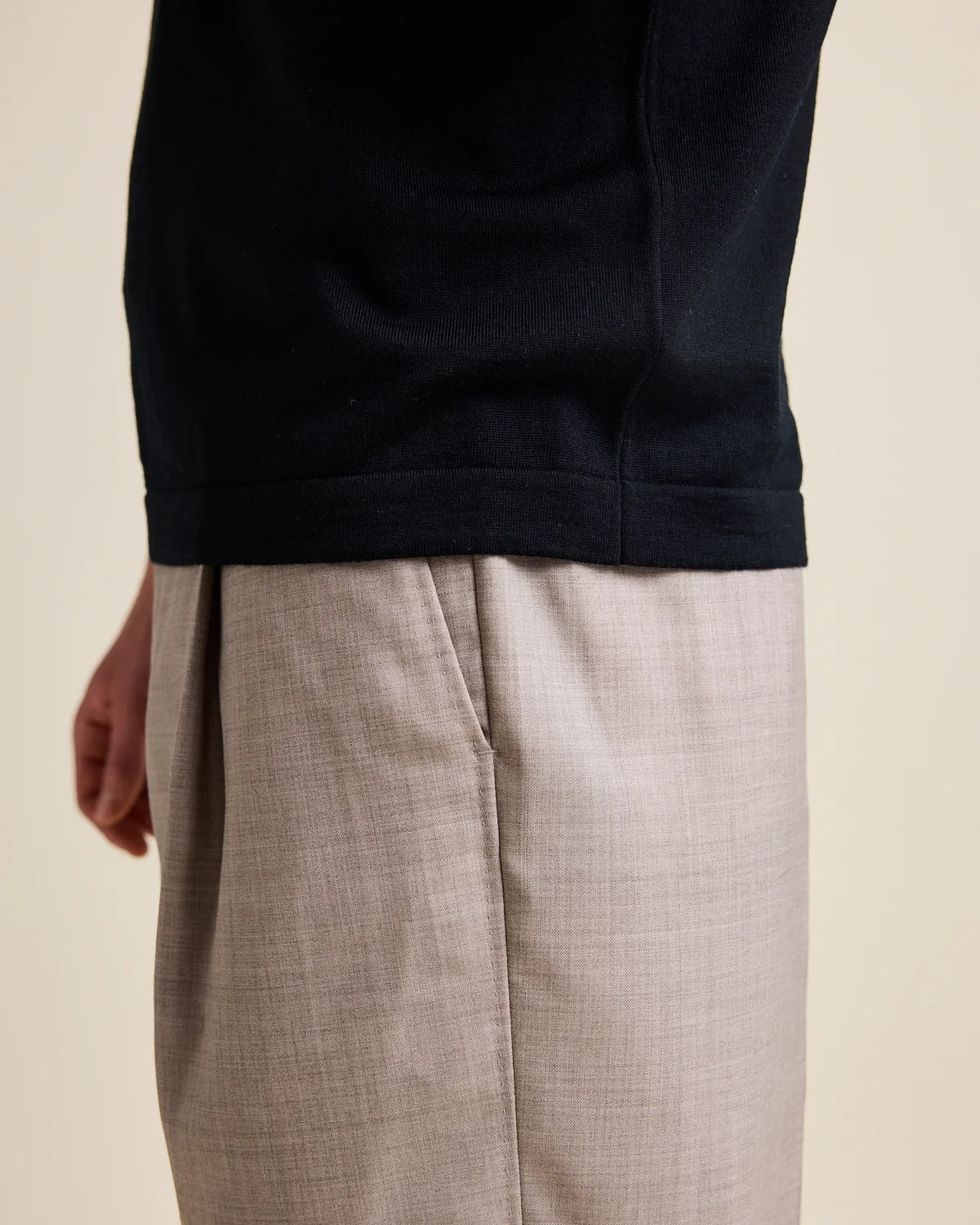 Close up of the rib hem cfrom a men’s merino wool polo-shirt in from the brand Wolk.