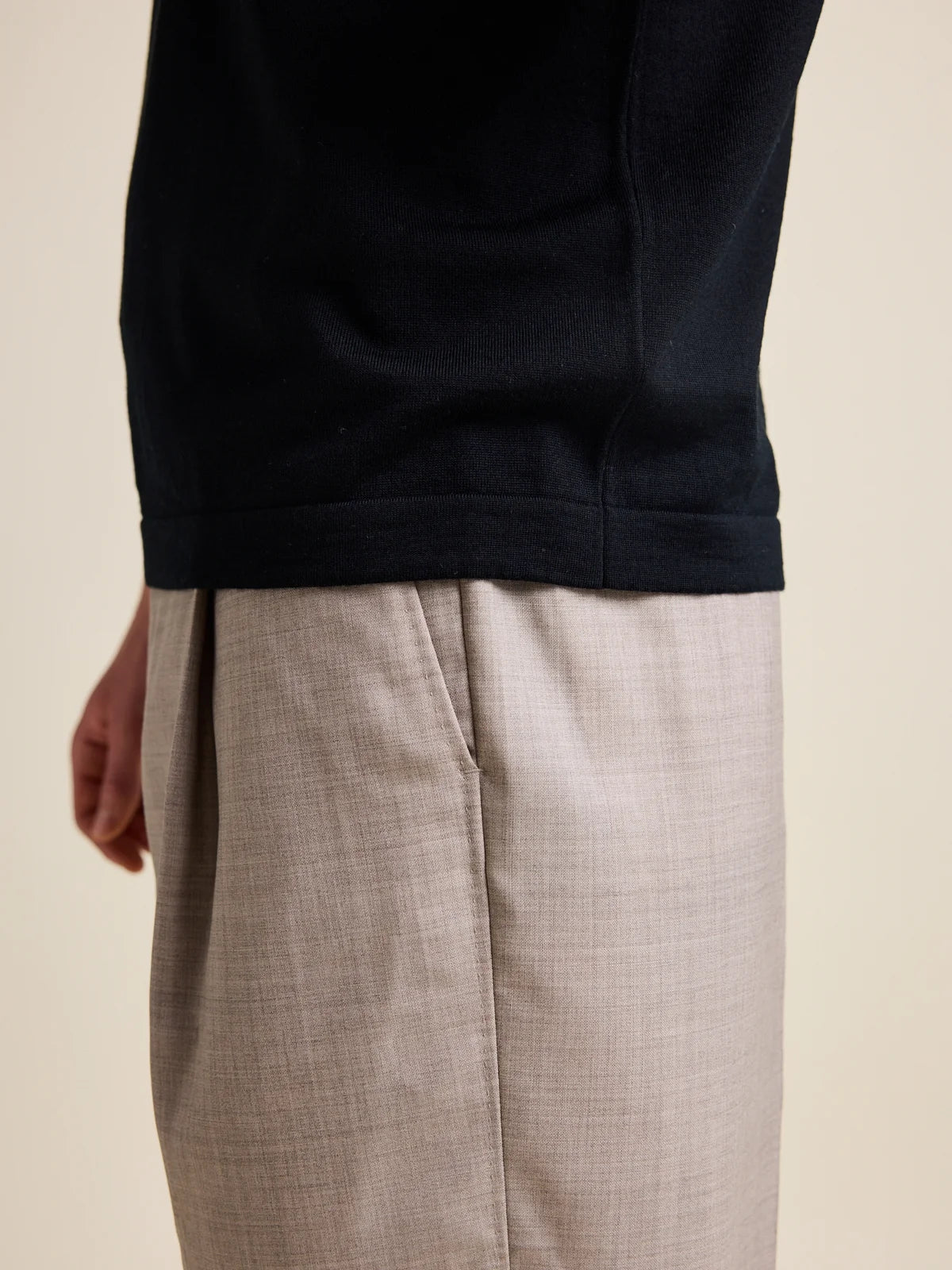 Close up of the rib hem cfrom a men’s merino wool polo-shirt in from the brand Wolk.