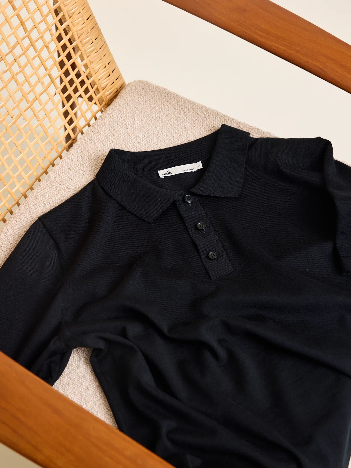 Wolk knitted merino wool polo in black with buttoned collar and short sleeves. Made from Cashwool yarn.