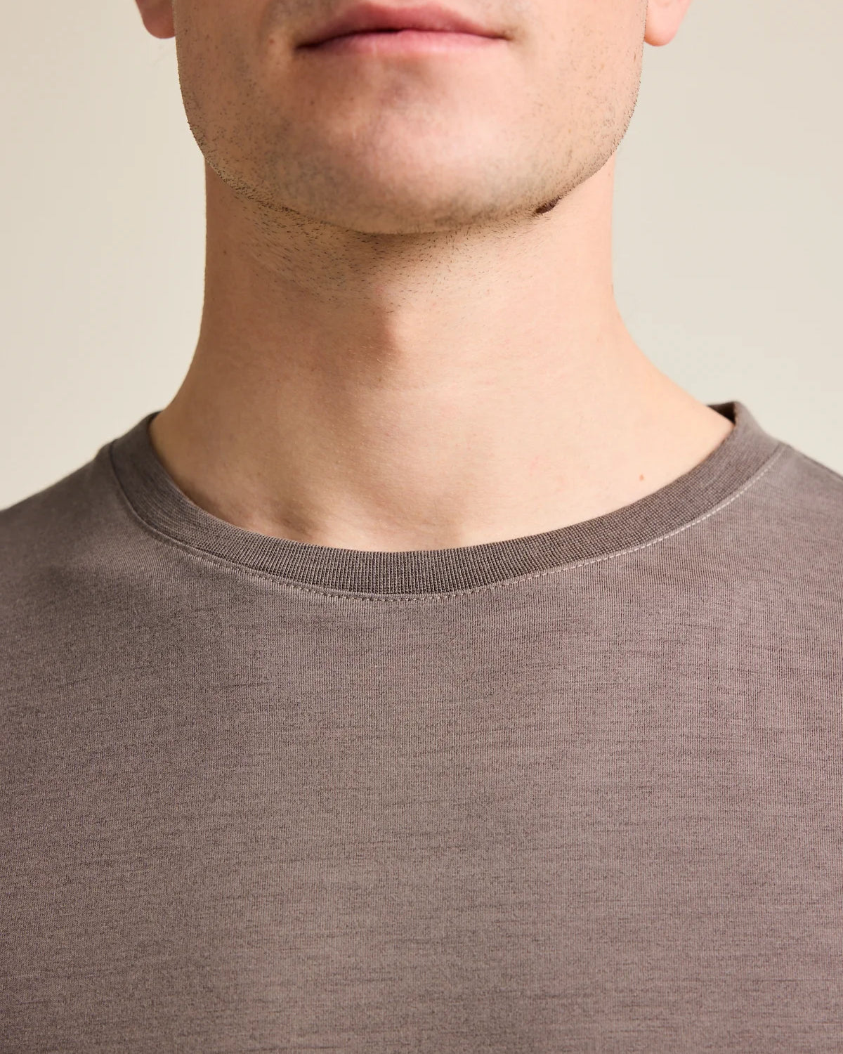 Detail shot of the chocolate brown crew neck collar from Wolk's men's merino wool T-shirt collection.