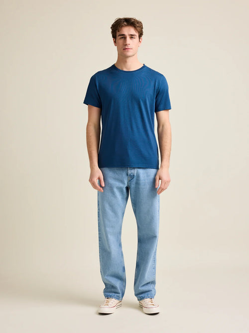 Full front view of Wolk's merino wool T-shirt for men in a medium blue color, styled for both comfort and performance.