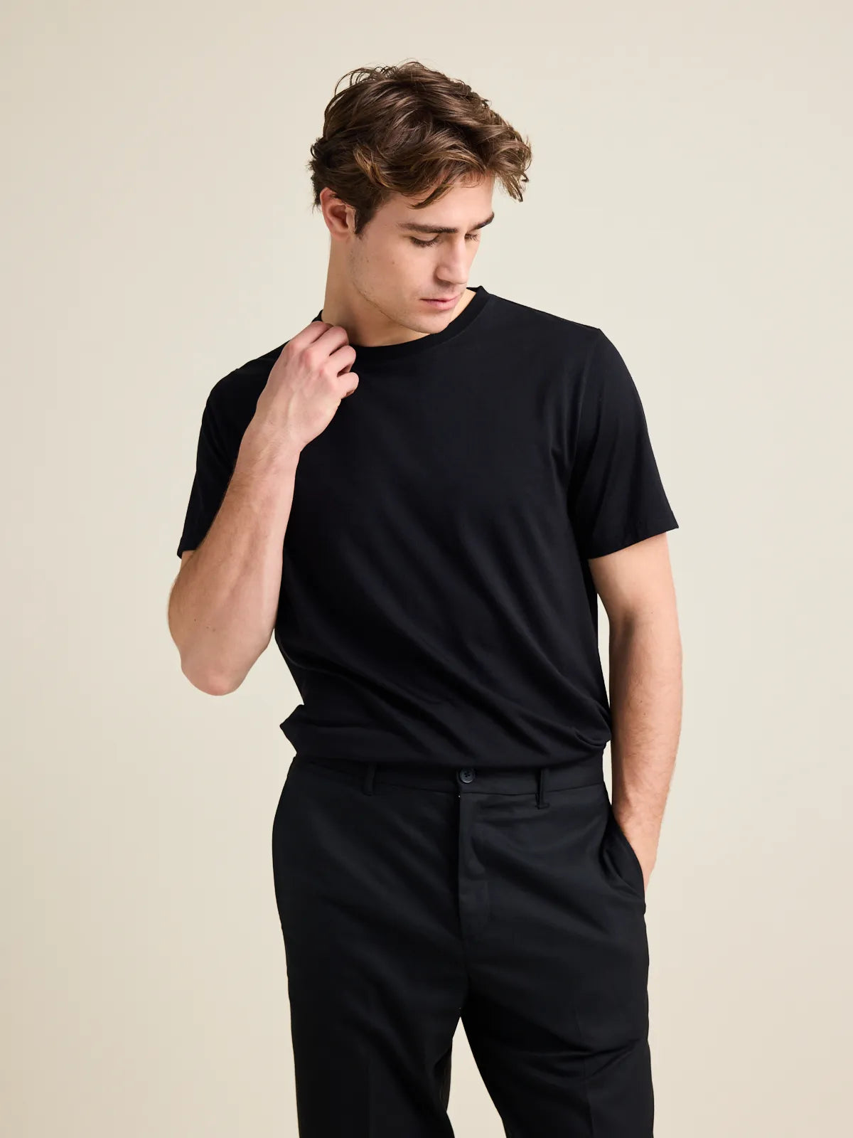 Front view of a men's black merino T-shirt, crew neck style, designed by Wolk.