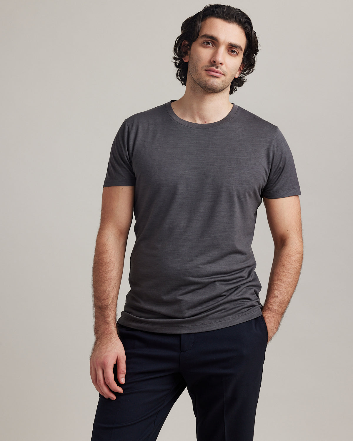Front view of Wolk's merino wool T-shirt for men in dark grey melange, designed for style and breathability.