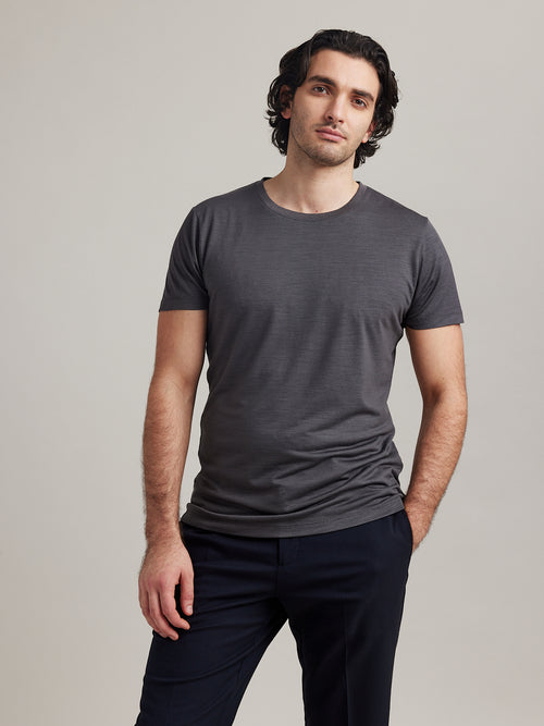 Front view of Wolk's merino wool T-shirt for men in dark grey melange, designed for style and breathability.