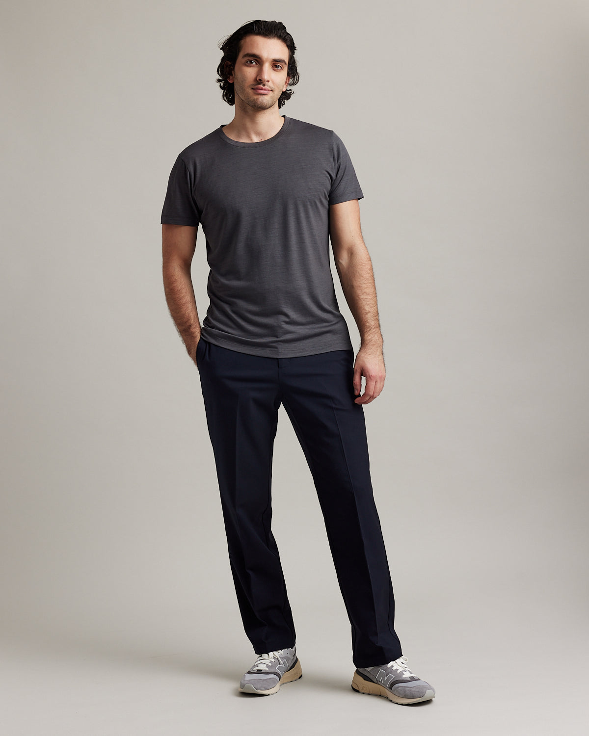 Wolk's dark grey men's merino wool T-shirt in a studio setting, showcasing crew-neck design.