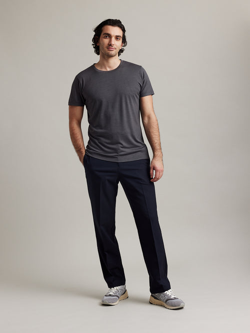 Wolk's dark grey men's merino wool T-shirt in a studio setting, showcasing crew-neck design.