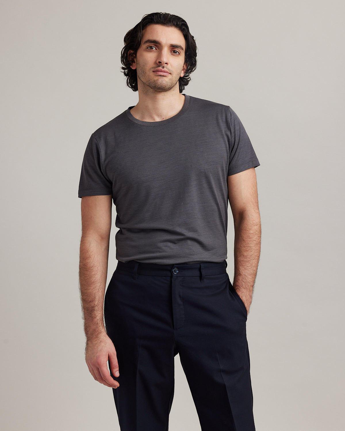 Man wearing short sleeved Climaforce merino wool T-shirt in dark grey color from Wolk