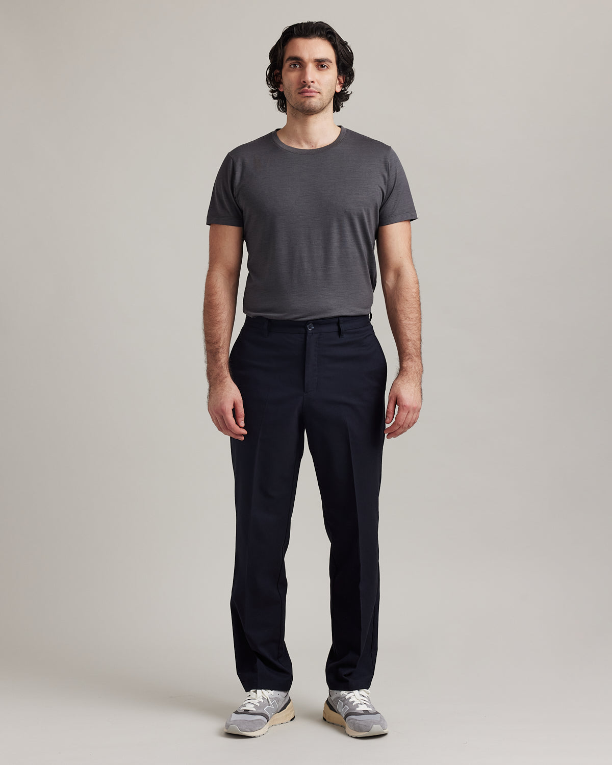 Wolk's dark grey men's merino wool T-shirt in a studio setting, showcasing crew-neck design.
