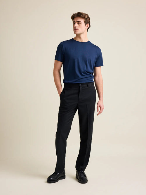 Men's navy blue merino wool T-shirt from Wolk, modeled in a studio setting with a focus on the crew neck and regular fit.