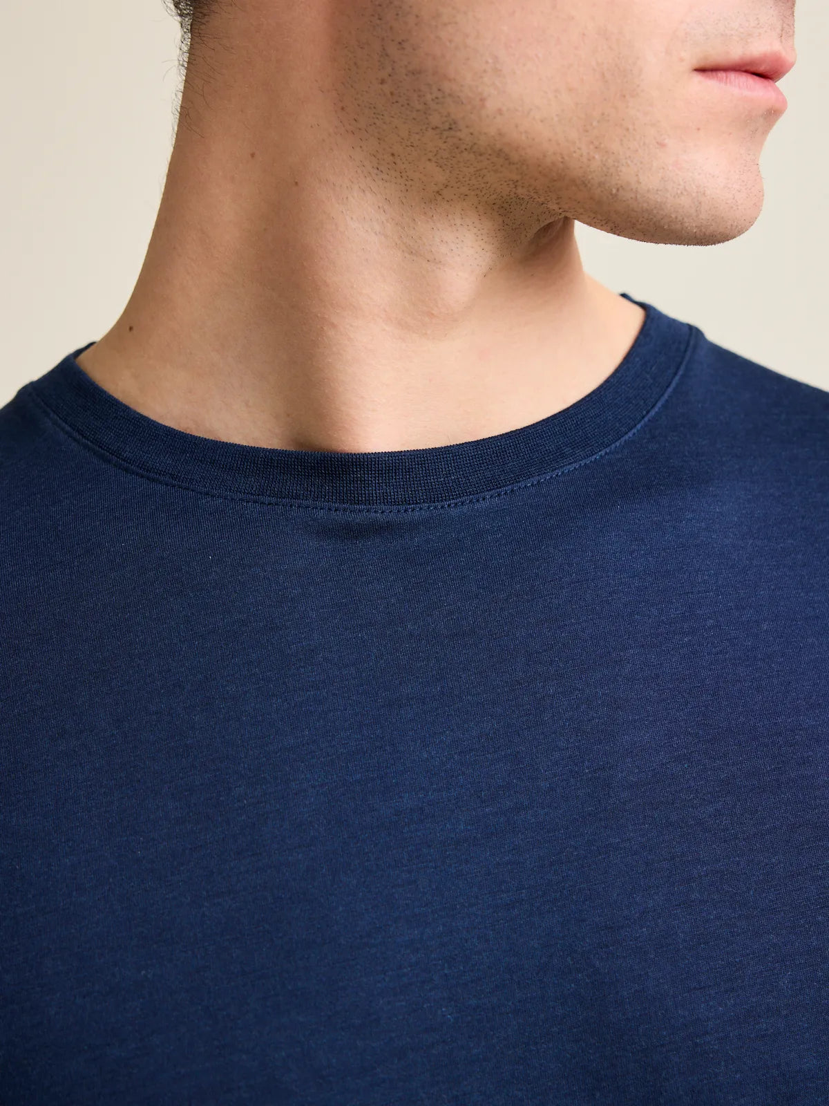 Detail shot of the dark navy crew neck collar from Wolk's men's merino wool T-shirt collection.