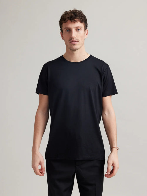 Front view of a men's black T-shirt, crew neck style, designed by Wolk.