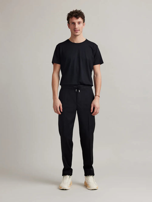Full front view of Wolk's merino wool T-shirt for men in black, styled for both comfort and performance.