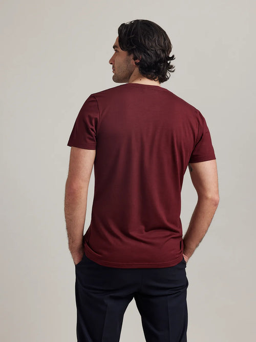 Rear perspective of Wolk's burgundy merino wool T-shirt for men, showcasing the clean back design.