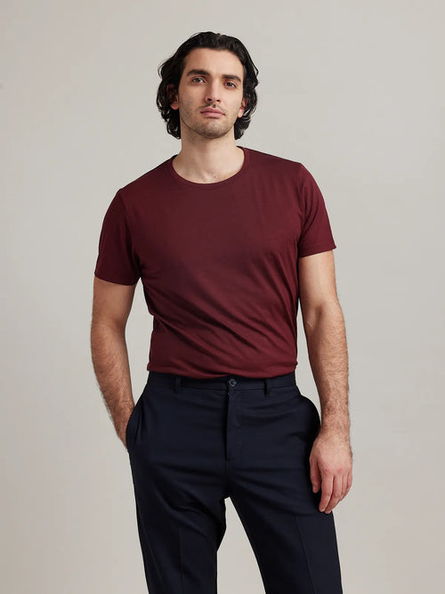Studio shot of a men's merino wool T-shirt in burgundy, designed by Wolk.