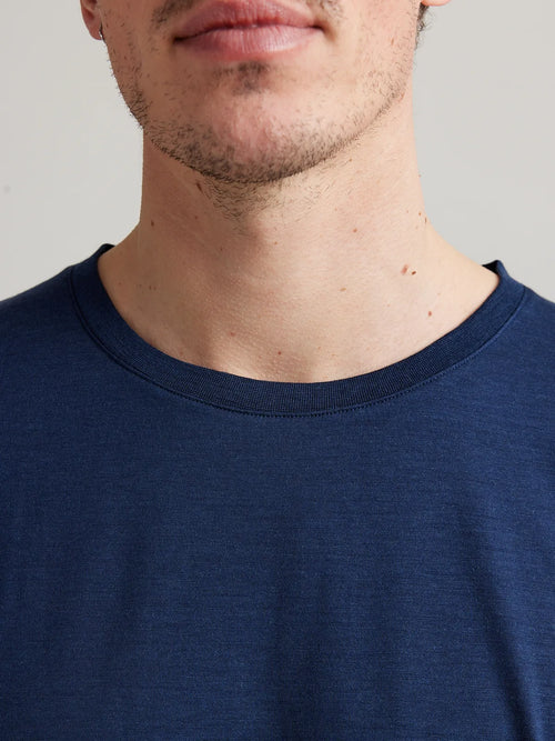 Detail shot of the dark navy melange crew neck collar from Wolk's men's merino wool T-shirt collection.