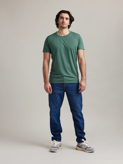 Full front view of Wolk's merino wool T-shirt for men in medium green, in a plain design without print.