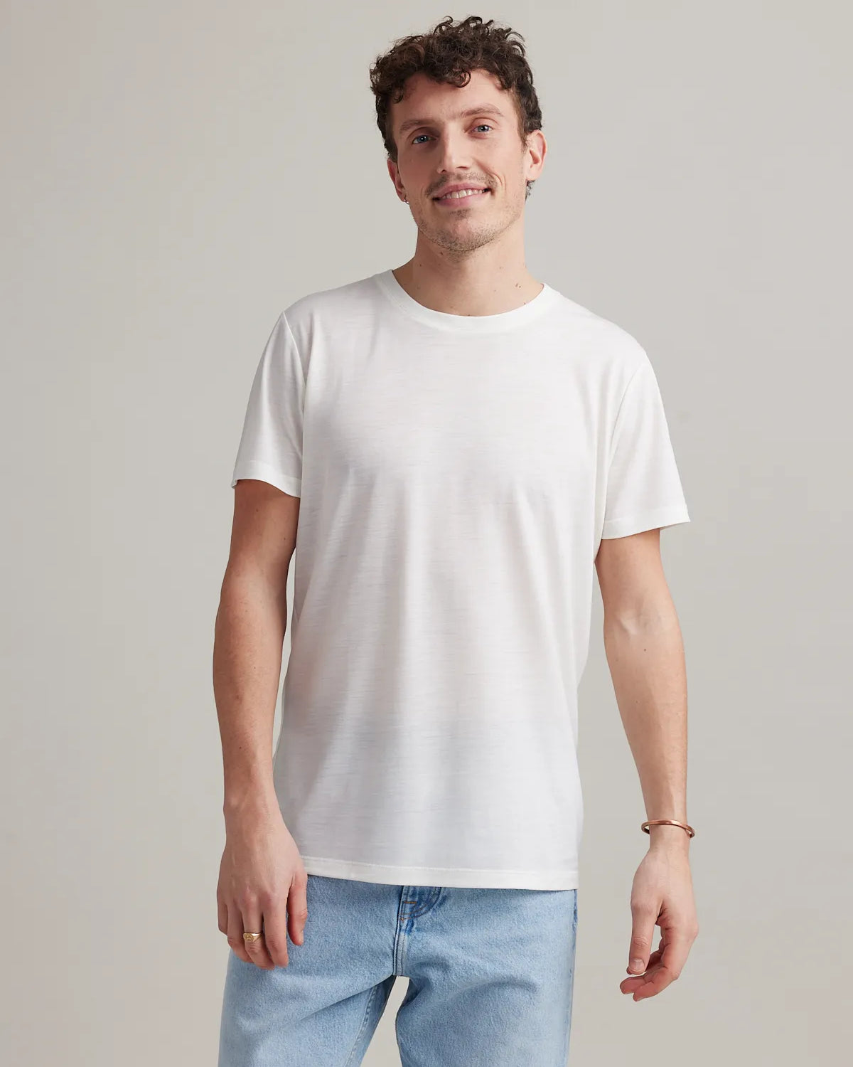 Man wearing white men's merino wool T-shirt with round neck and short sleeves made in Europe