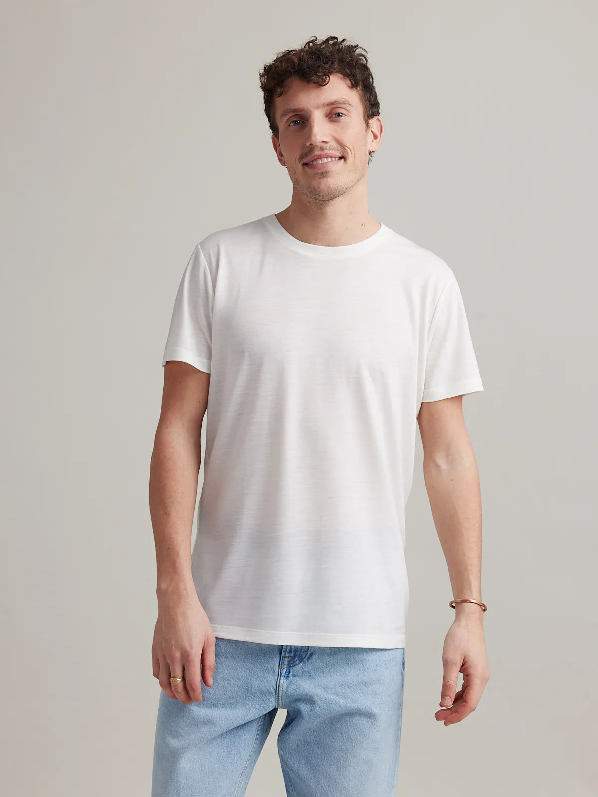 Man wearing white men's merino wool T-shirt with round neck and short sleeves made in Europe